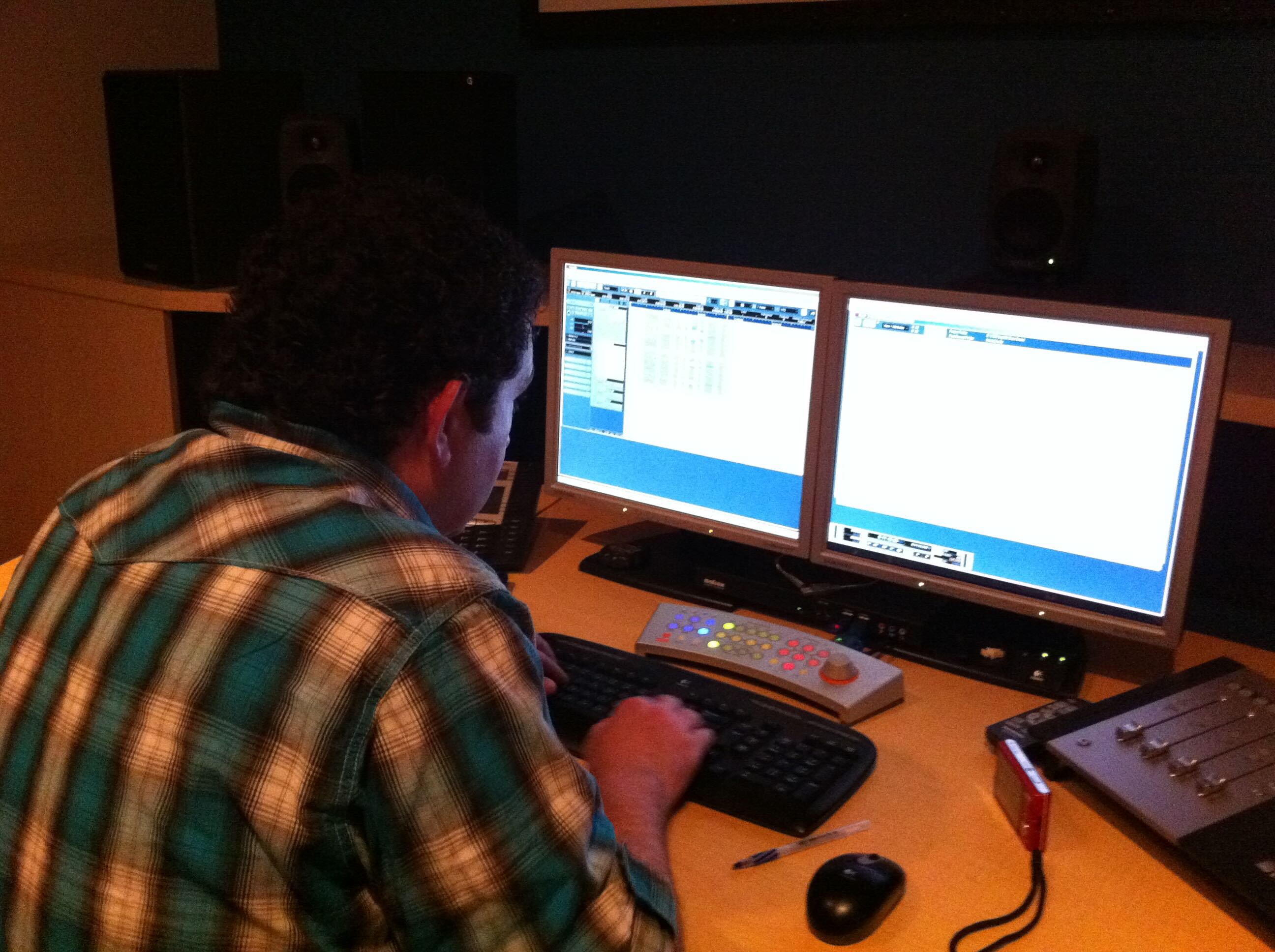 A recording engineer working at the studio’s audio workstation during the Drumline session
